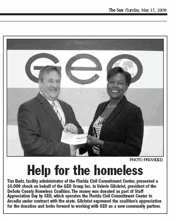 Valerie Gilchrist accepts a generous donation from GEO's Tim Budz. The photo appeared in The Arcadian on Sunday, May 31